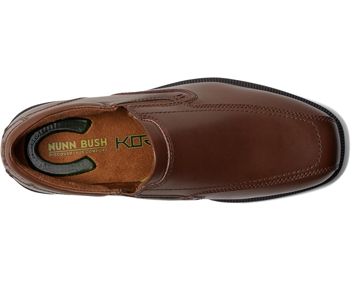 Men's Nunn Bush Bleeker Street Bicycle Toe Slip-On with KORE Slip Resistant Walking Comfort Technology Cognac